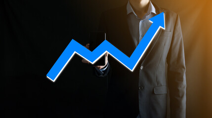 Businessman man holding a graph with positive profits growth. plan graph growth and increase of chart positive indicators in his business.more profitable and growing.