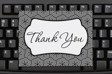 Wall Mural - Thank You message on a greeting card on black keyboard