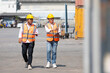 © offsuperphoto - factory workers or engineers talking and exploring container in factory workshop