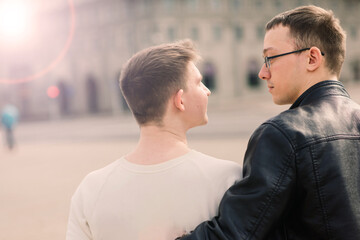 Young gay couple smiling happy and hugging at the city.