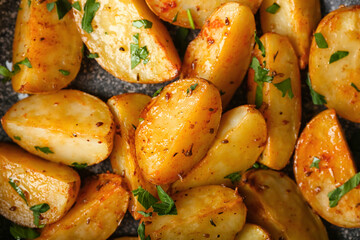 Tasty fried potatoes with parsley, closeup