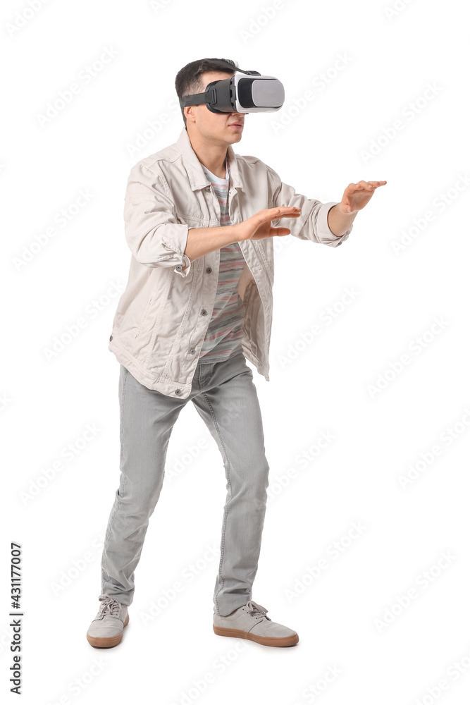 Young man with virtual reality glasses on white background