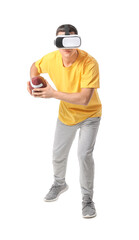 Wall Mural - Sporty young man with virtual reality glasses playing American football on white background
