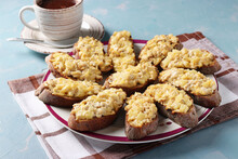 Baked Homemade Toasts With Chicken, Cheese, Pineapple And Garlic As Well Cup Of Coffee On A Light Blue Background.