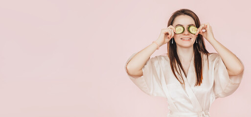 Wall Mural - girl make homemade face beauty masks. cucumbers for the freshness of the skin around the eyes. woman