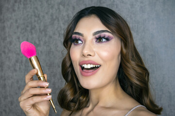 Closeup portrait of beautiful woman with bright make-up and pink lips. Attractive model with a pink lipstick.