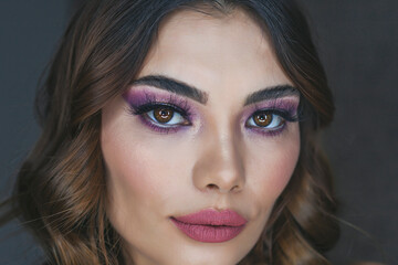 Closeup portrait of beautiful woman with bright make-up and pink lips. Attractive model with a pink lipstick.