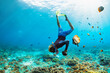 Happy family vacation. Man in snorkeling mask with camera dive underwater with tropical fishes in coral reef sea pool. Travel lifestyle, water sport outdoor adventure, swimming on summer beach holiday
