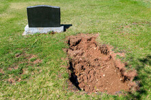 Fresh Grave By An Empty Tombstone