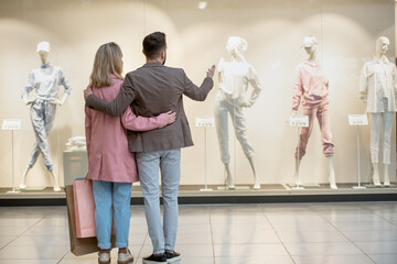 Wall Mural - A group of people looking at a display during shopping