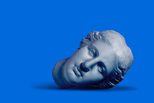 Composition With Gypsum Greek Goddess Plaster Head On Blue Background, Sleeping Beauty Concept
