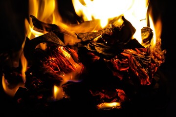 Log fire close-up. The texture of the flame of fire. Abstract burning flame flame for banner background. Fire in the night and smoldering embers close-up. Burning paper.Fire in the fireplace close-up.