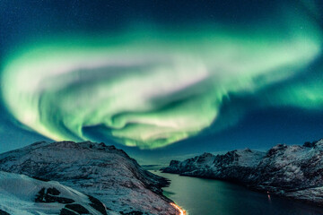 Wall Mural - Vertical shot of a night winter landscape with Northern lights reflection on the river