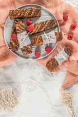 Wall Mural - Cereal bars with raspberries on kitchen counter top.