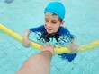© OLEKSANDR - boy in the pool learns to swim
