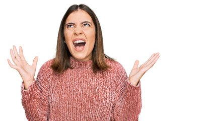 Poster - Young beautiful woman wearing casual clothes crazy and mad shouting and yelling with aggressive expression and arms raised. frustration concept.