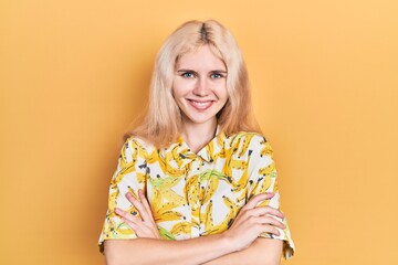 Canvas Print - Beautiful caucasian woman with blond hair wearing colorful shirt happy face smiling with crossed arms looking at the camera. positive person.