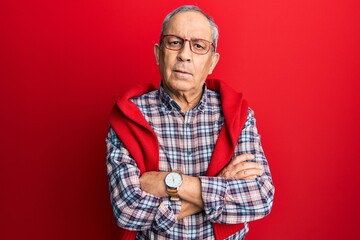 Poster - Handsome senior man with grey hair wearing casual clothes and glasses relaxed with serious expression on face. simple and natural looking at the camera.