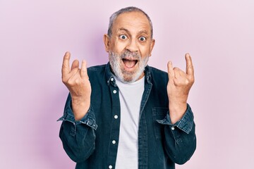 Sticker - Handsome senior man with beard doing rock gesture celebrating crazy and amazed for success with open eyes screaming excited.