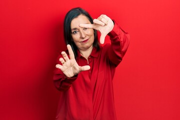 Canvas Print - Middle age hispanic woman wearing casual clothes doing frame using hands palms and fingers, camera perspective