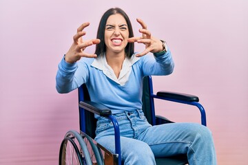 Canvas Print - Beautiful woman with blue eyes sitting on wheelchair shouting frustrated with rage, hands trying to strangle, yelling mad