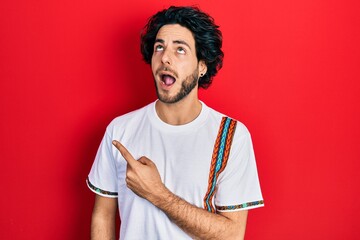 Sticker - Handsome hispanic man pointing with fingers to the side angry and mad screaming frustrated and furious, shouting with anger looking up.