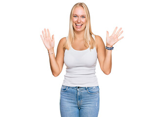 Poster - Young blonde girl wearing casual style with sleeveless shirt showing and pointing up with fingers number ten while smiling confident and happy.