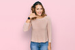 © Krakenimages.com - Beautiful young caucasian woman wearing casual sweater smiling doing phone gesture with hand and fingers like talking on the telephone. communicating concepts.