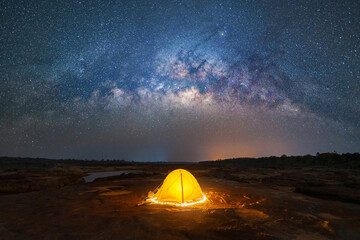 camping tent under sky on mountain hills with the milky way with bright stars at night in travel on 