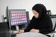 © .shock - Muslim female graphic designer working on computer