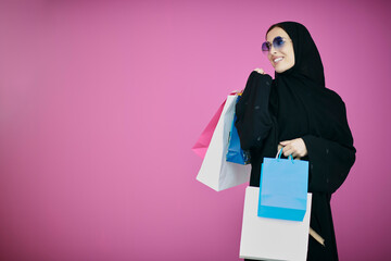 Happy muslim girl posing with shopping bags