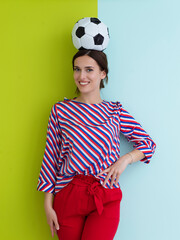 Wall Mural - Portrait of young European woman holding soccer ball on her head