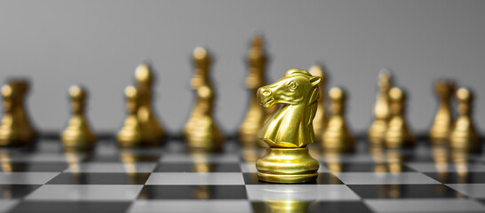 Wall Mural - gold Chess knight figure Stand out from the crowd on Chessboard background. Strategy, leadership, business, teamwork, different, Unique and Human resource management concept