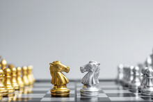 Gold And Silver Chess Knight (horse) Figure On Chessboard Against Opponent Or Enemy. Strategy, Conflict, Management, Business Planning, Tactic, Politic, Communication And Leader Concept