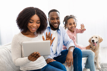 Poster - Black family having videocall using laptop waving hands