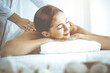 © rogerphoto - Beautiful brunette woman enjoying back massage with closed eyes. Spa and medicine concept