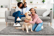 Young black girl hugging dog posing at home