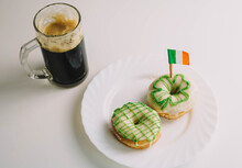 Imagen De Un Desayuno Irlandes Para Celebrar San Patricio, Compuesto Por Dos Donuts Caseros Y Una Jarra De Cerveza Negra.