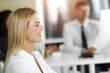 © Iryna - Blond business woman using computer at workplace in sunny office. Working for pleasure and success