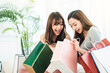 © Tom Wang - Happy girls opening the paper shopping bags at home