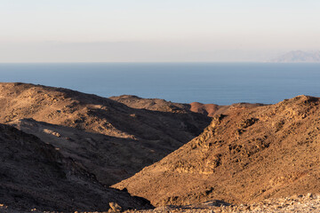 Wall Mural - Arid desert mountains against the backdrop of the Red Sea. Shlomo mountain, Eilat Israel. Morning Daylight . High quality photo