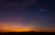 Crescent  Moon Sky On Dark Blue Dusk In The Evening With Sunset And Beautiful Sunlight On Dark Cloud, Symbols Of Islamic Religion In Ramadan