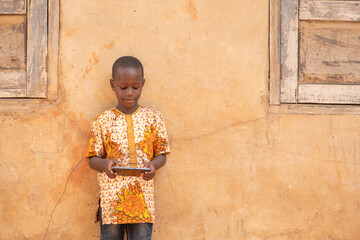 Wall Mural - african kid holding a smart phone