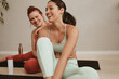 © Jacob Lund - Smiling women friends relaxing after fitness training