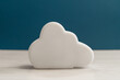 White cloud symbol on a table. Concept for cloud computing, data exchange and online storage.