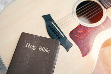 Christians worship God with a guitar with the Holy Bible. reading the Bible and sharing the gospel with copy space for the word of god.