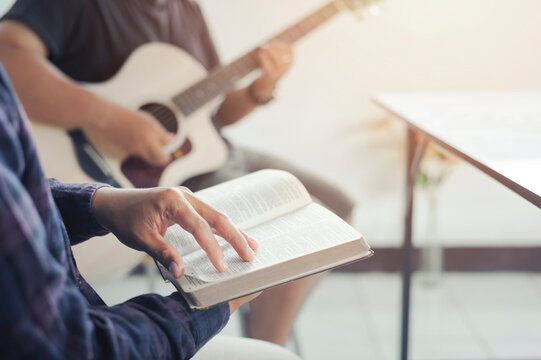 Christian groups sing worship and praying and seek the blessings of God with the Holy Bible. reading the Bible and sharing the gospel with copy space.