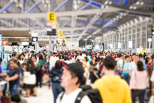Blurred Many Passengers People Of Crowd Anonymous Walking At The Airport. Scene Of Airport With Passengers Activity. Terminal Departure Check-in At Airport. Travel International And Business Concept.