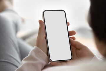 Crop close up back view of young pregnant Caucasian woman hold use modern smartphone browse wireless internet. Wife look at white empty mockup screen on cellphone talk on video virtual call.