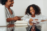 Fototapeta  - Happy student doing studies with teacher